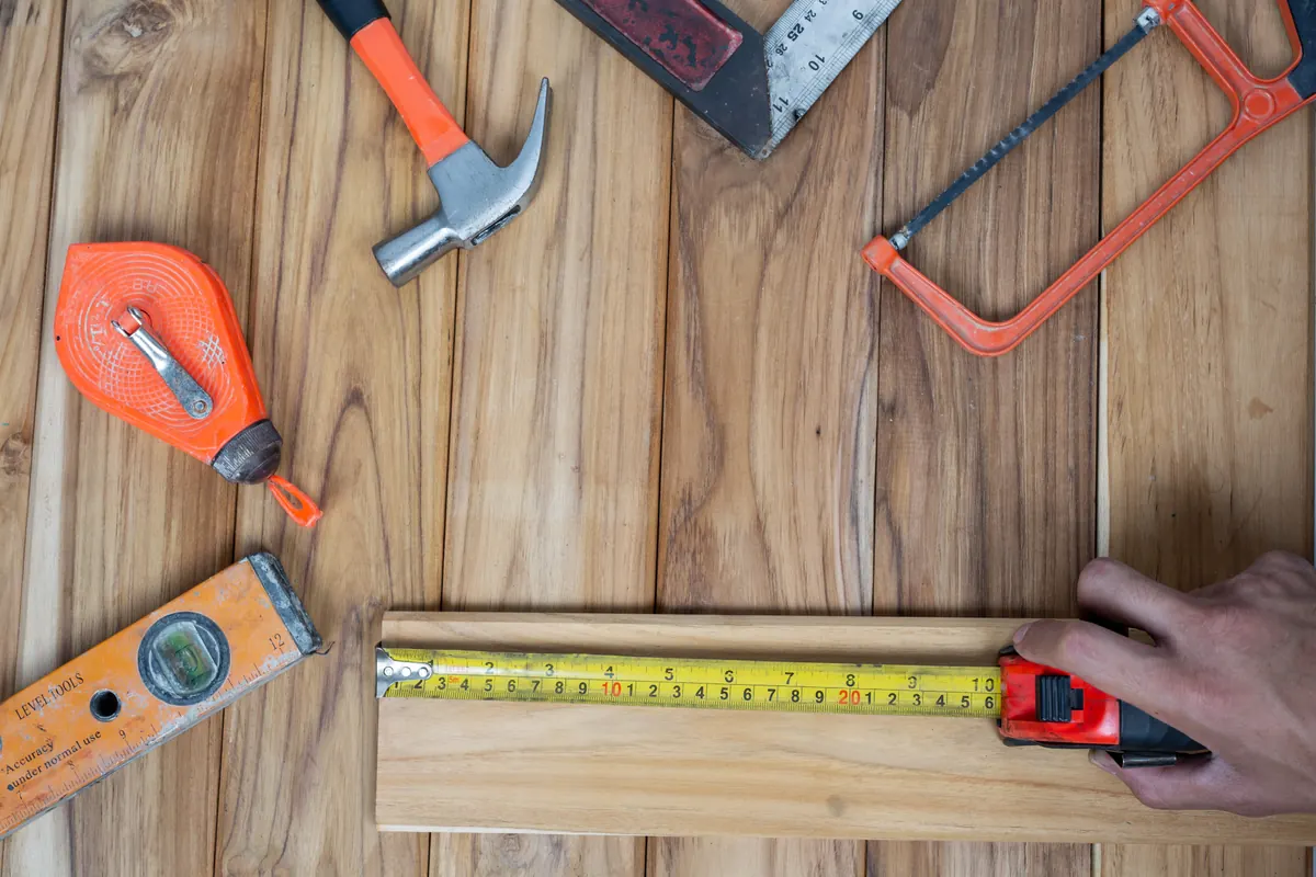 Flooring installation tool set resting on a wooden floor